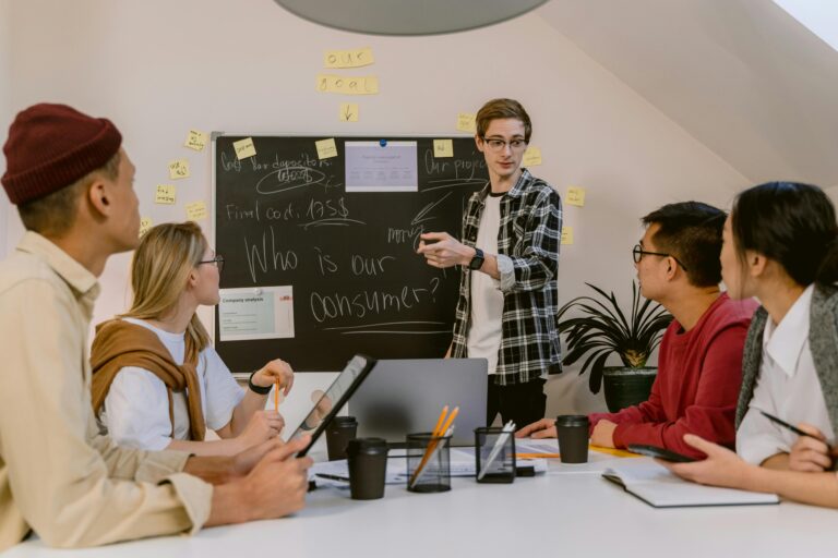 Young professionals discuss consumer strategies in a collaborative office meeting.